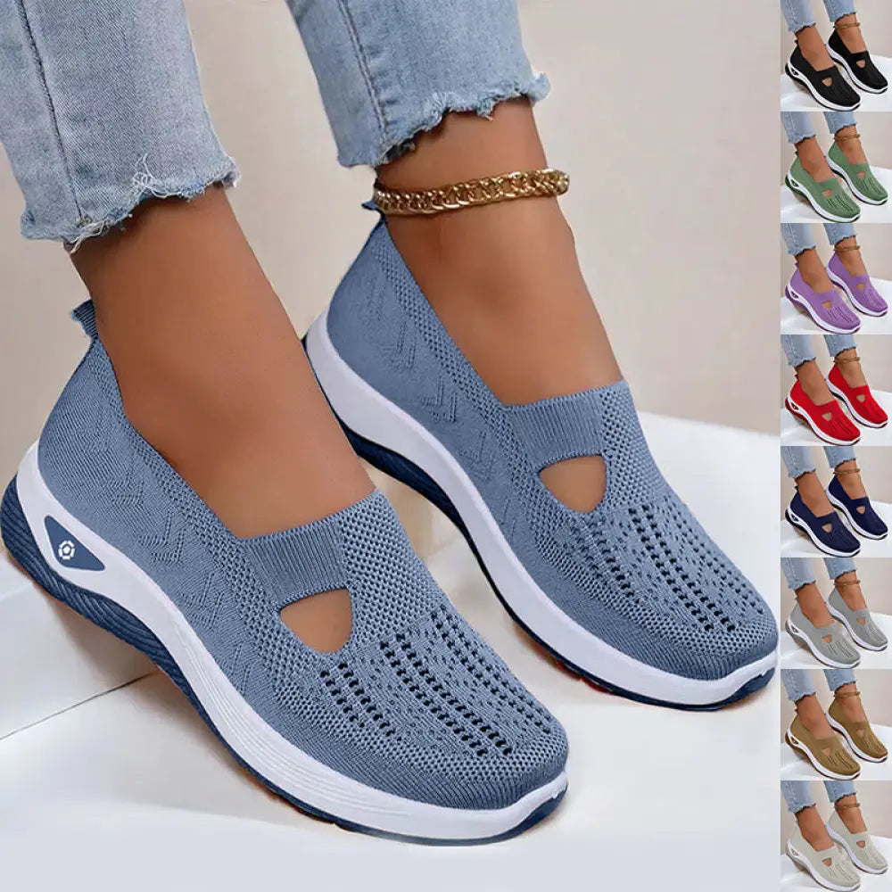 Light blue women’s breathable mesh slip-on casual flats with knitted upper and white navy rubber sole featuring t-shaped cutout