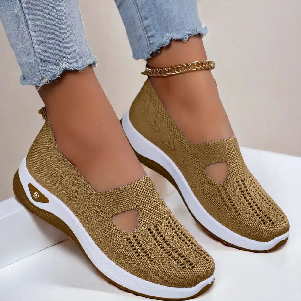Tan knitted slip-on women’s breathable mesh casual flats with white rubber sole and decorative cutouts