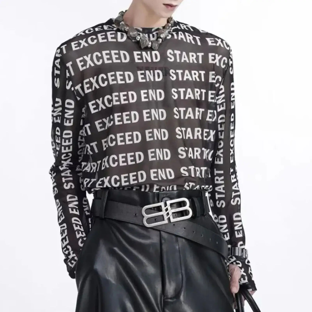 Black sheer mesh long sleeve men shirt with bold white exceed end start text print across the fabric