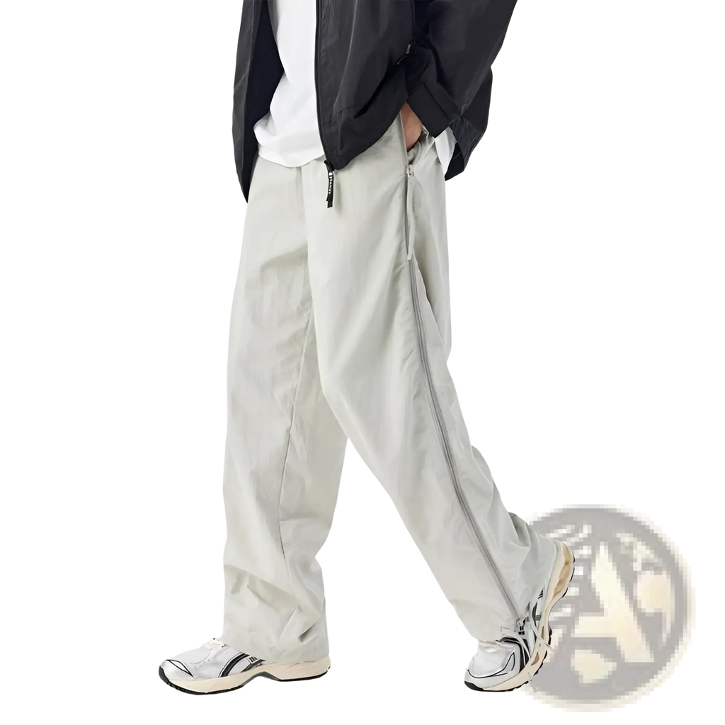Light gray mesh side panel utility hiking pants with wide legs and silver zippers down the outer sides