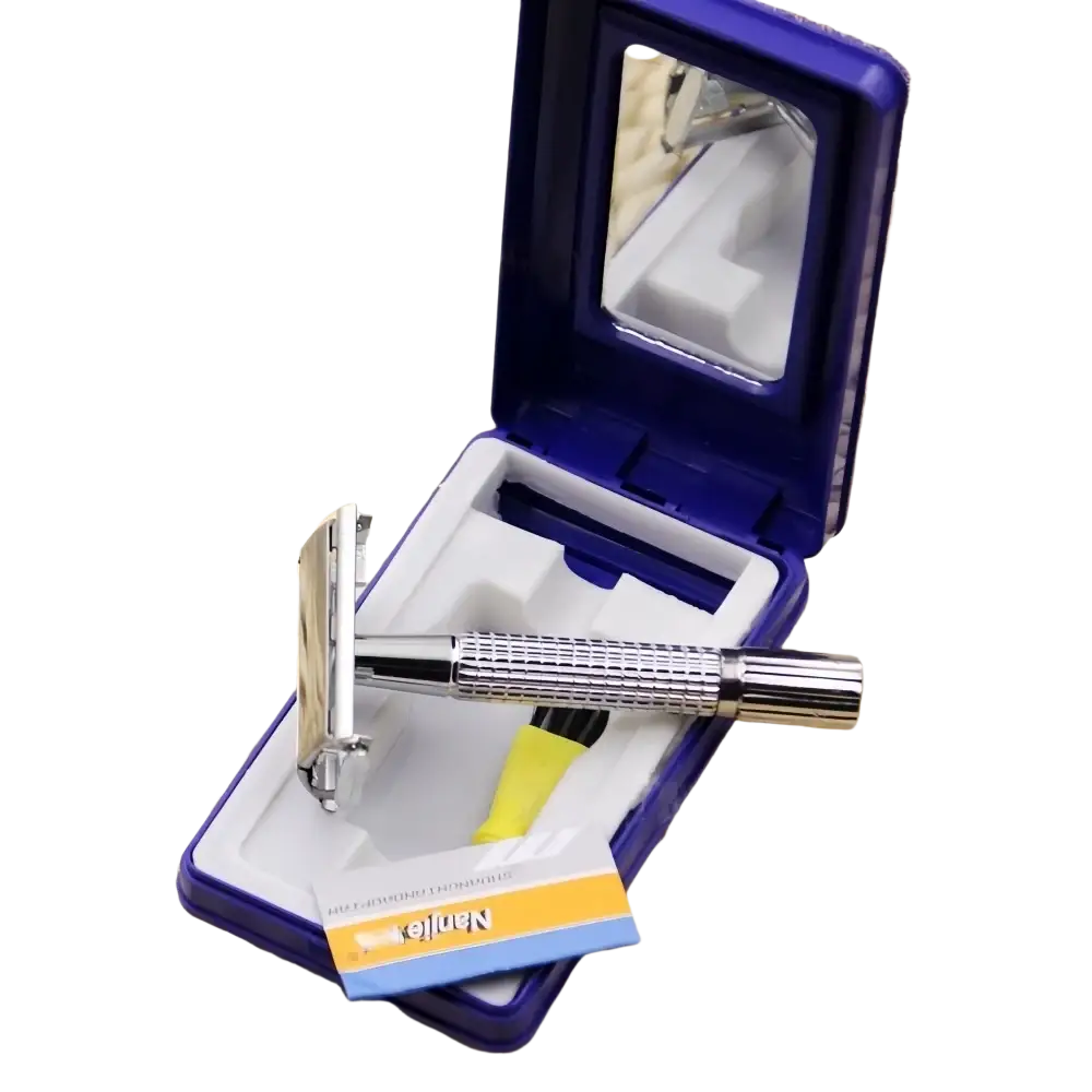 A sleek metal chrome safety razor with textured grip in an open blue case holding replacement blades and mirror