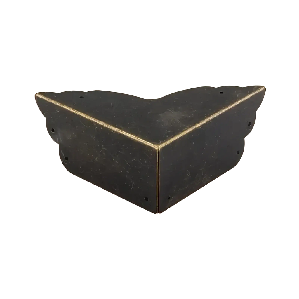 Antique brass-finished metal corner protector with scalloped edges and four pre-drilled holes for furniture and tables