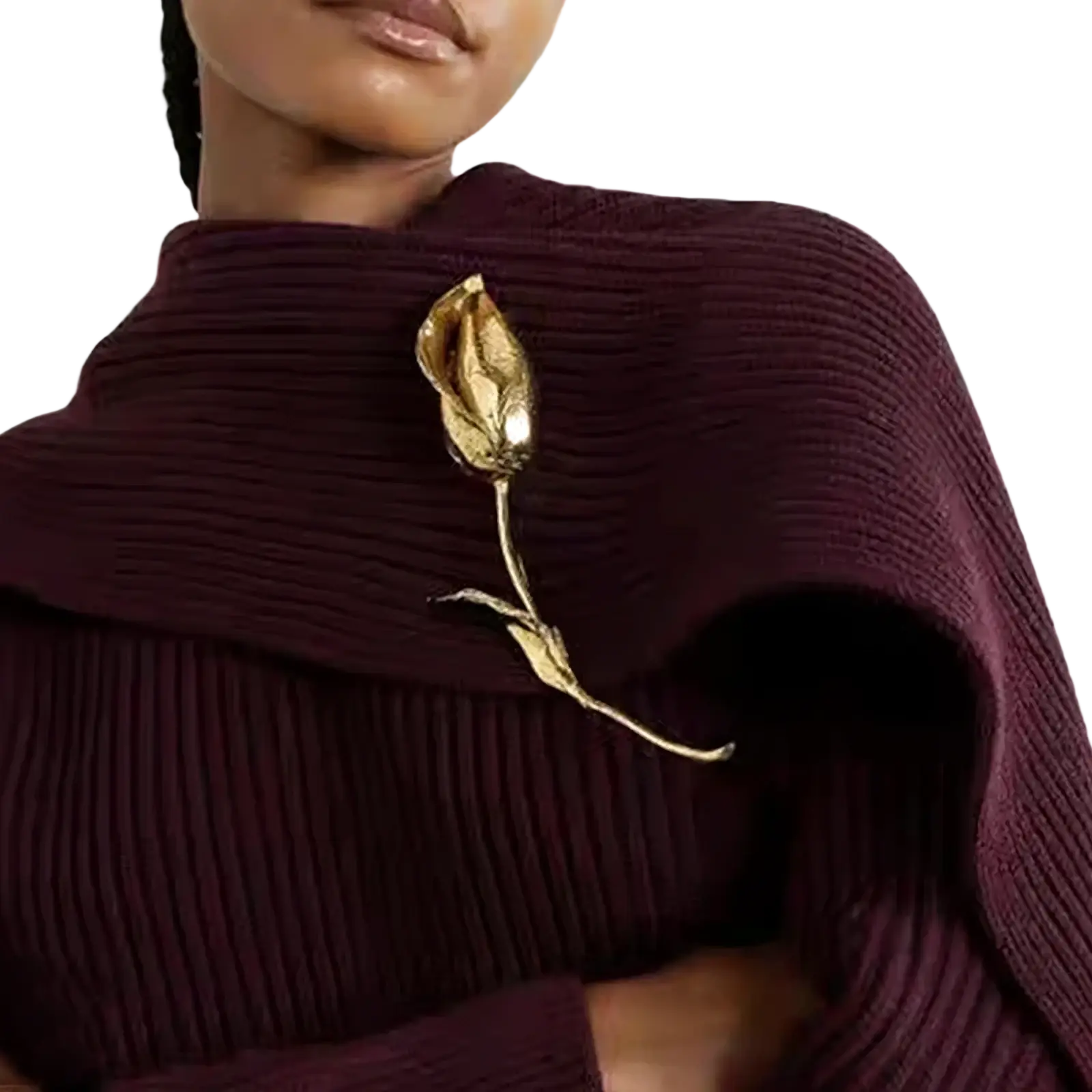 A gold-toned metal flower brooch pin with intricate petals on a maroon ribbed sweater high neckline