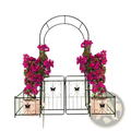 Black wrought iron metal garden arch with butterfly gate trellis arbor flanked by potted magenta bougainvillea plants