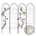 Black metal garden trellis with arched top and circular cutouts adorned with artificial pink roses climbing plants