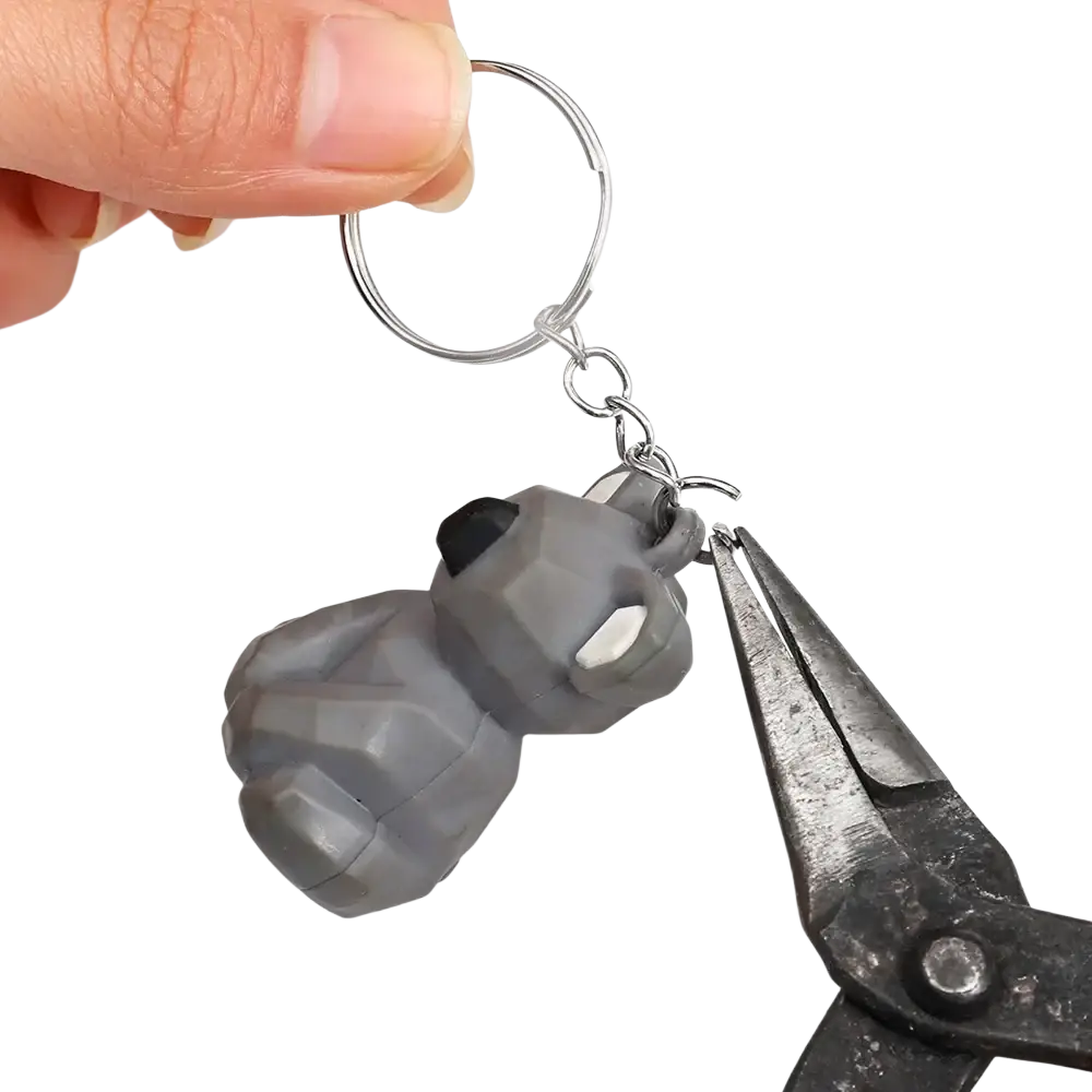 Gray faceted rubber metal keychain shaped like a stylized grenade with black and white accents and split ring chain