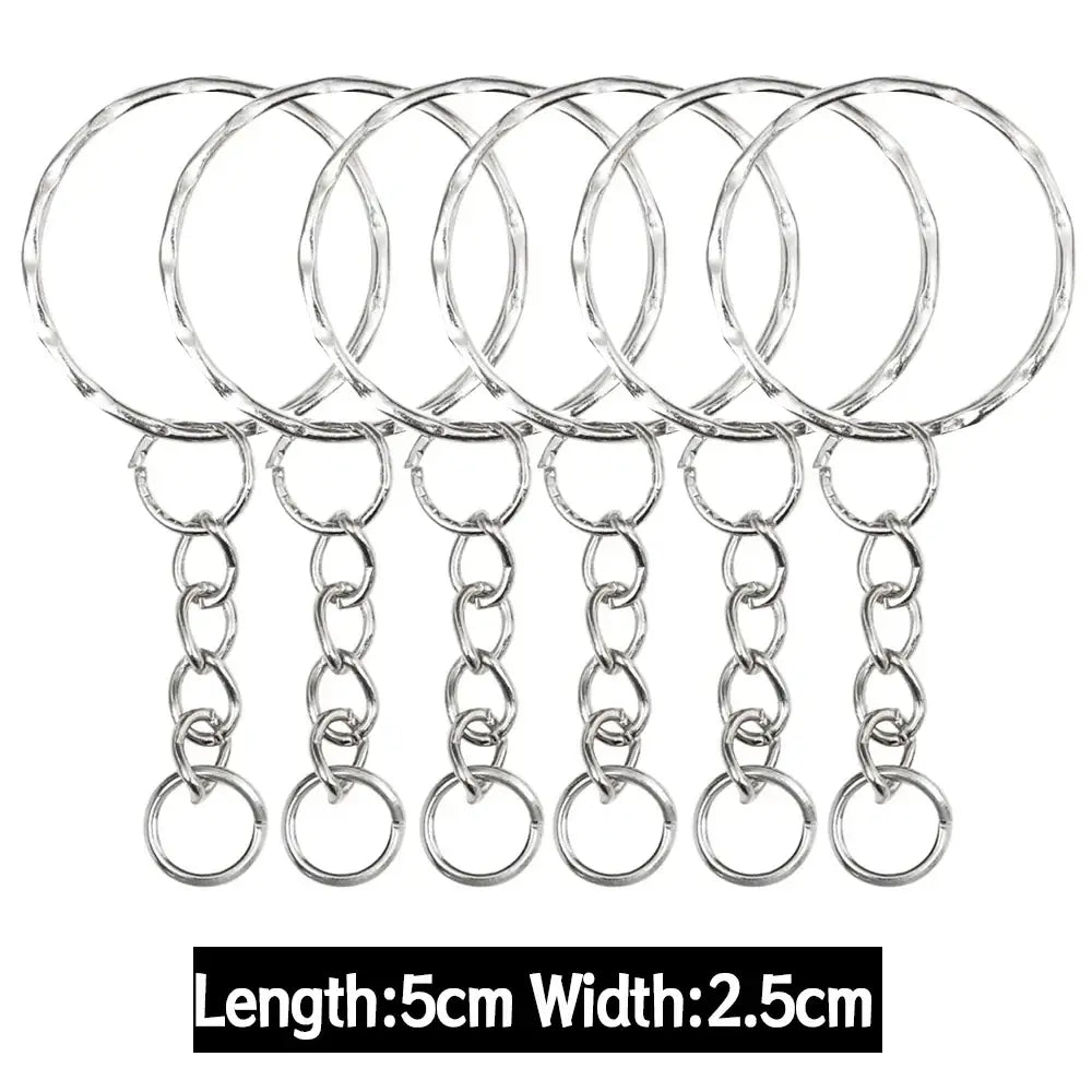 Set of six silver-toned metal keychains with split rings textured circular tops and short chain links