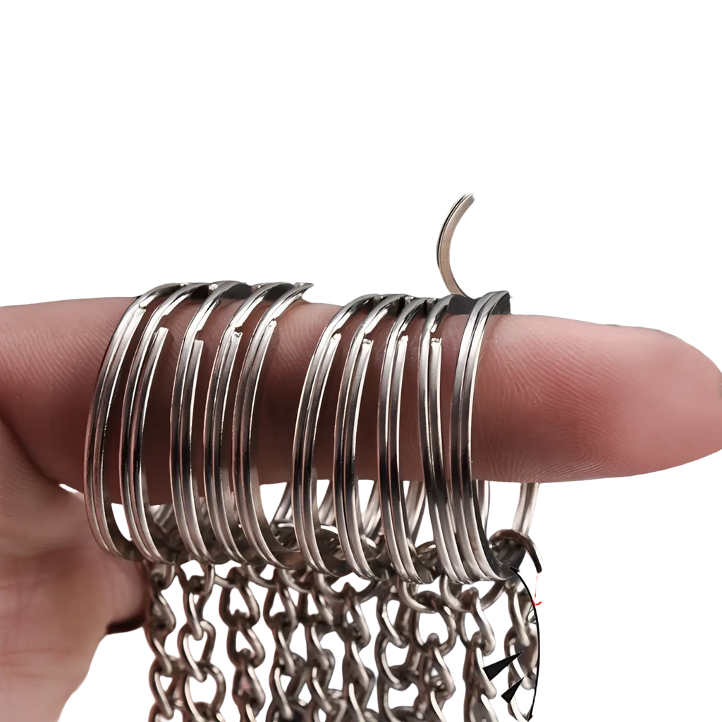 A stack of silver-toned metal keychains with split rings and chains featuring a smooth polished finish