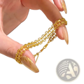 A delicate gold metal lace bracelet with an intricate interlocking circular design and adjustable clasp