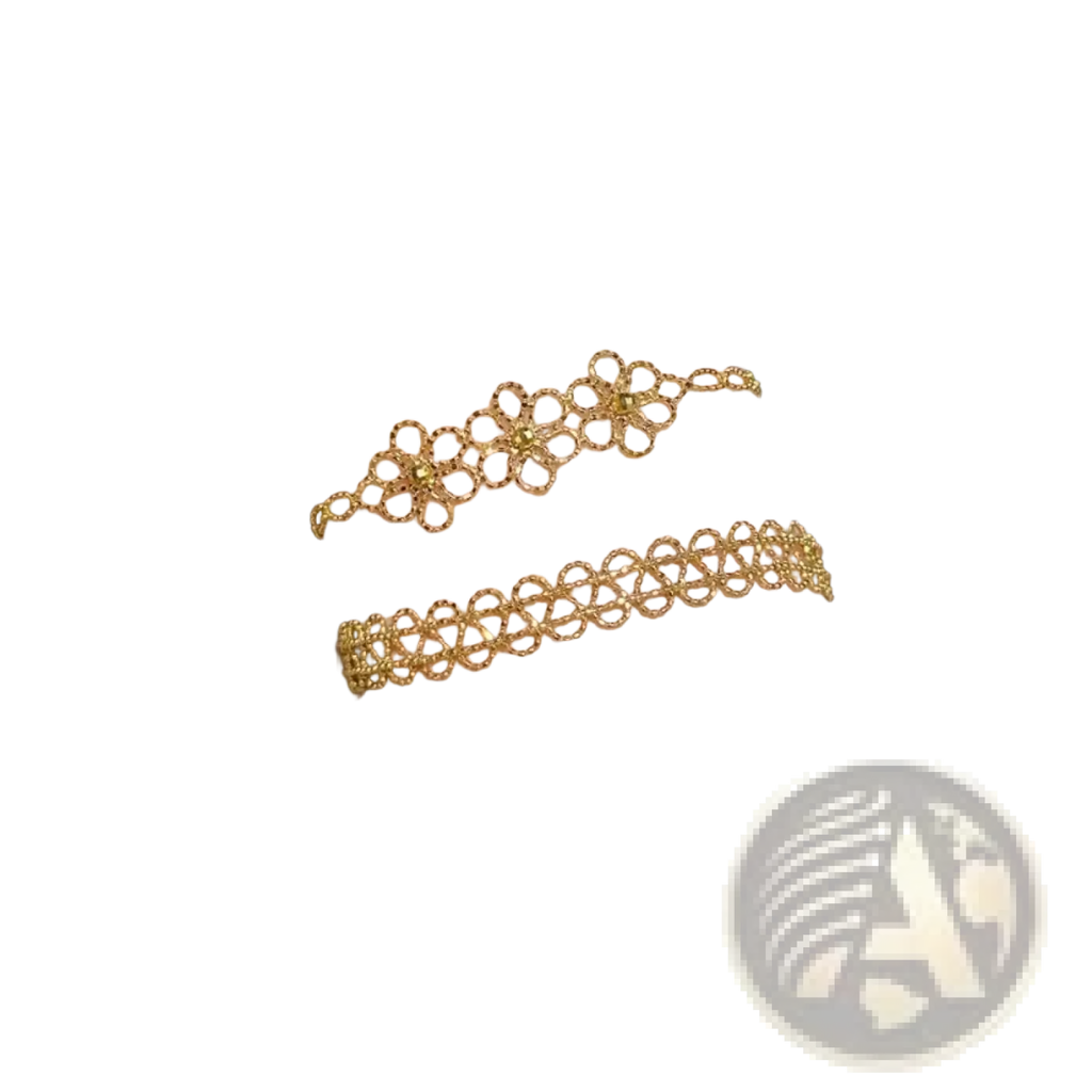 Two delicate gold-toned metal lace bracelets with floral pattern and fine linked chains adorn the wrist