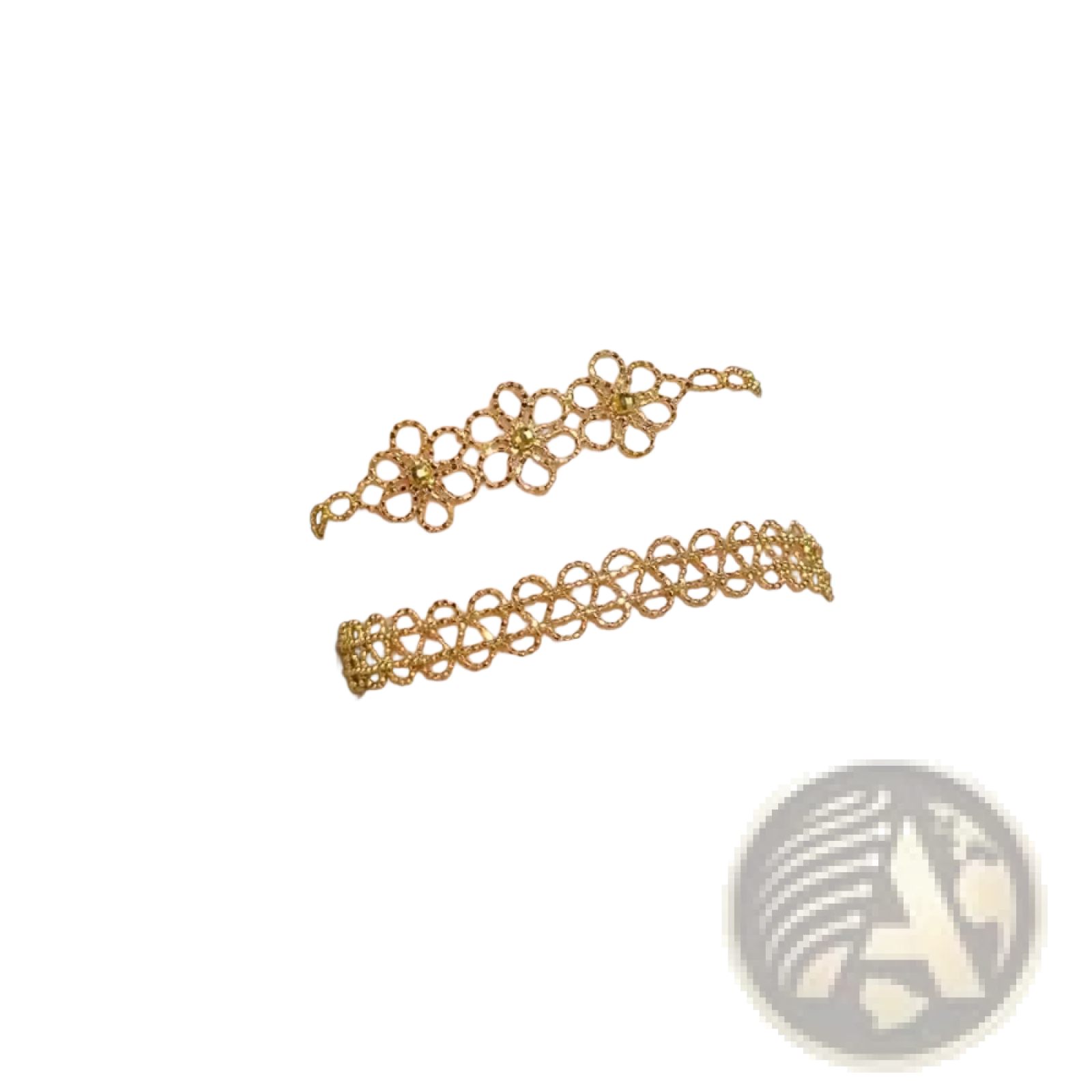 Two delicate gold-toned metal lace bracelets with floral pattern and fine linked chains adorn the wrist