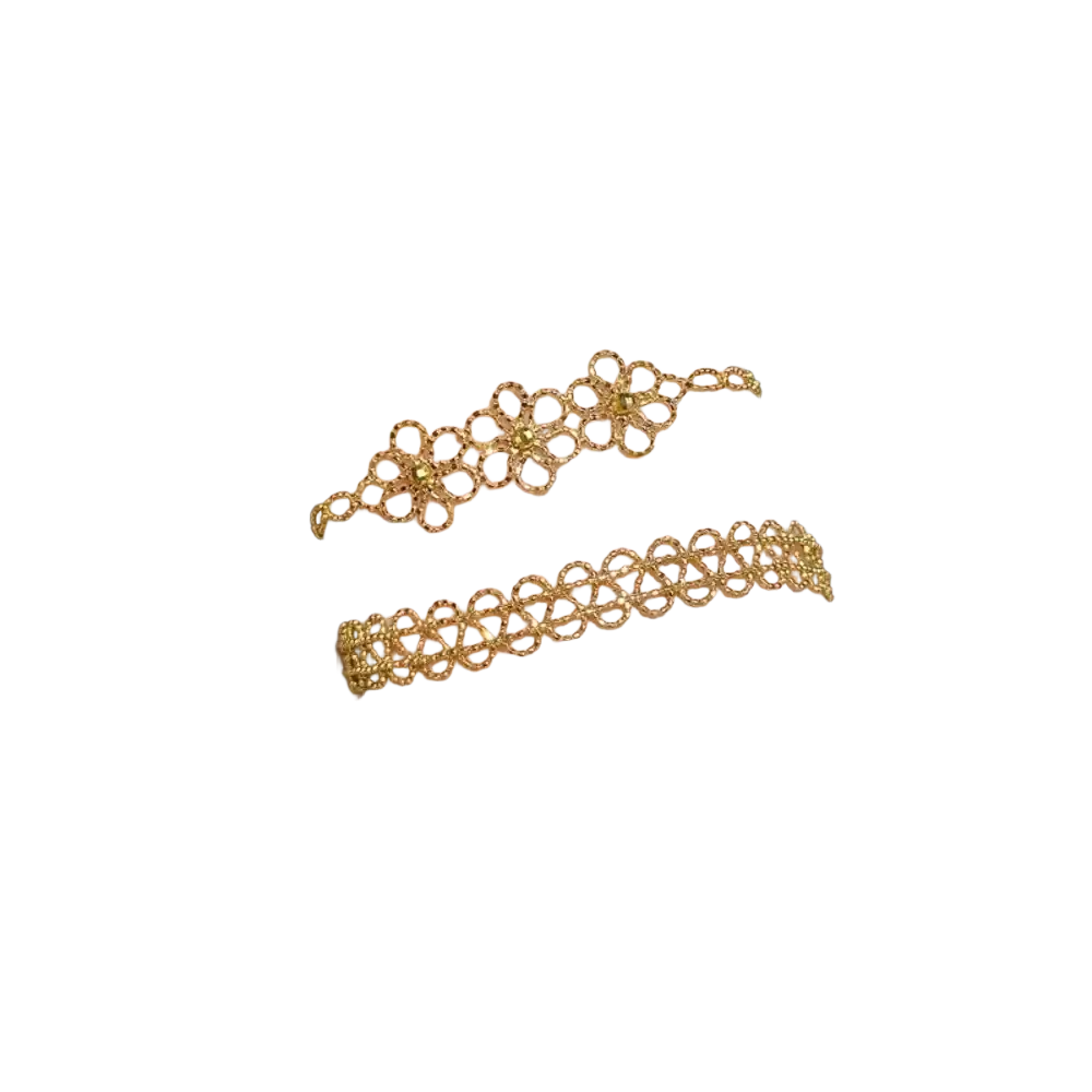 Two delicate gold-toned metal lace bracelets with floral pattern and fine linked chains adorn the wrist