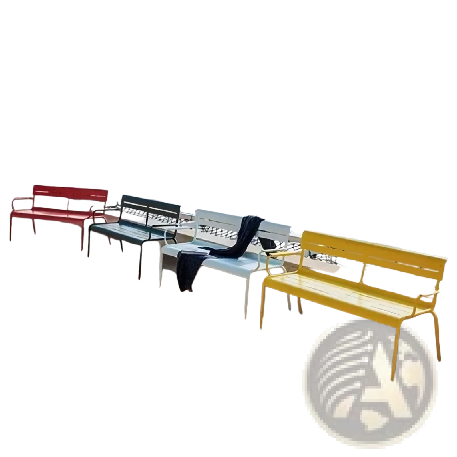 Brightly colored metal outdoor garden benches in red green and yellow with modern slatted design on sandy beach