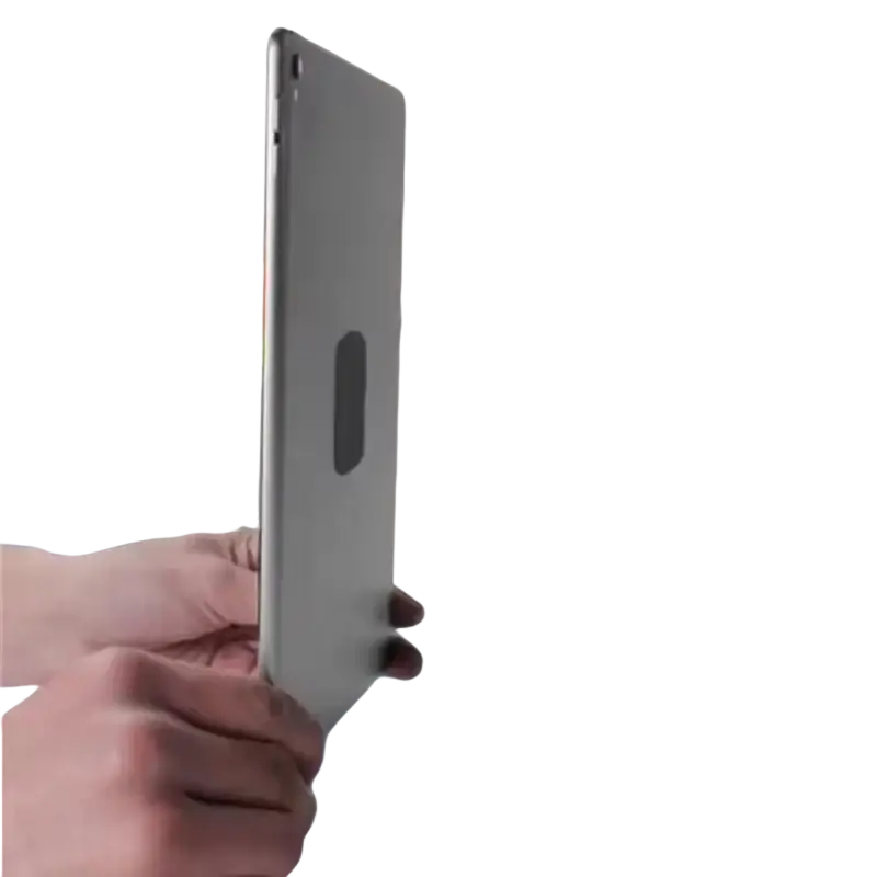 Black rectangular metal plate with rounded corners for universal car phone holder mounted on wooden surface