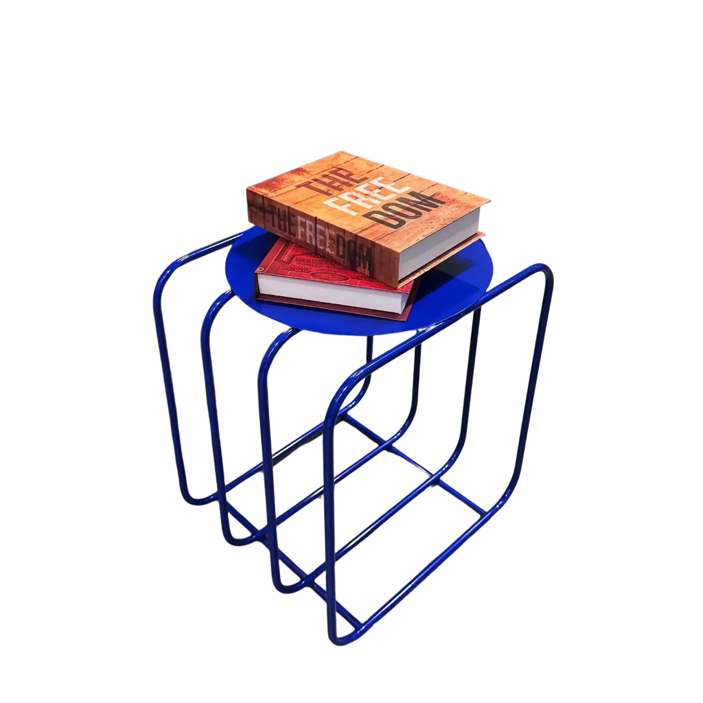Blue metal side table with curved frame and circular top featuring minimalist magazine rack storage design