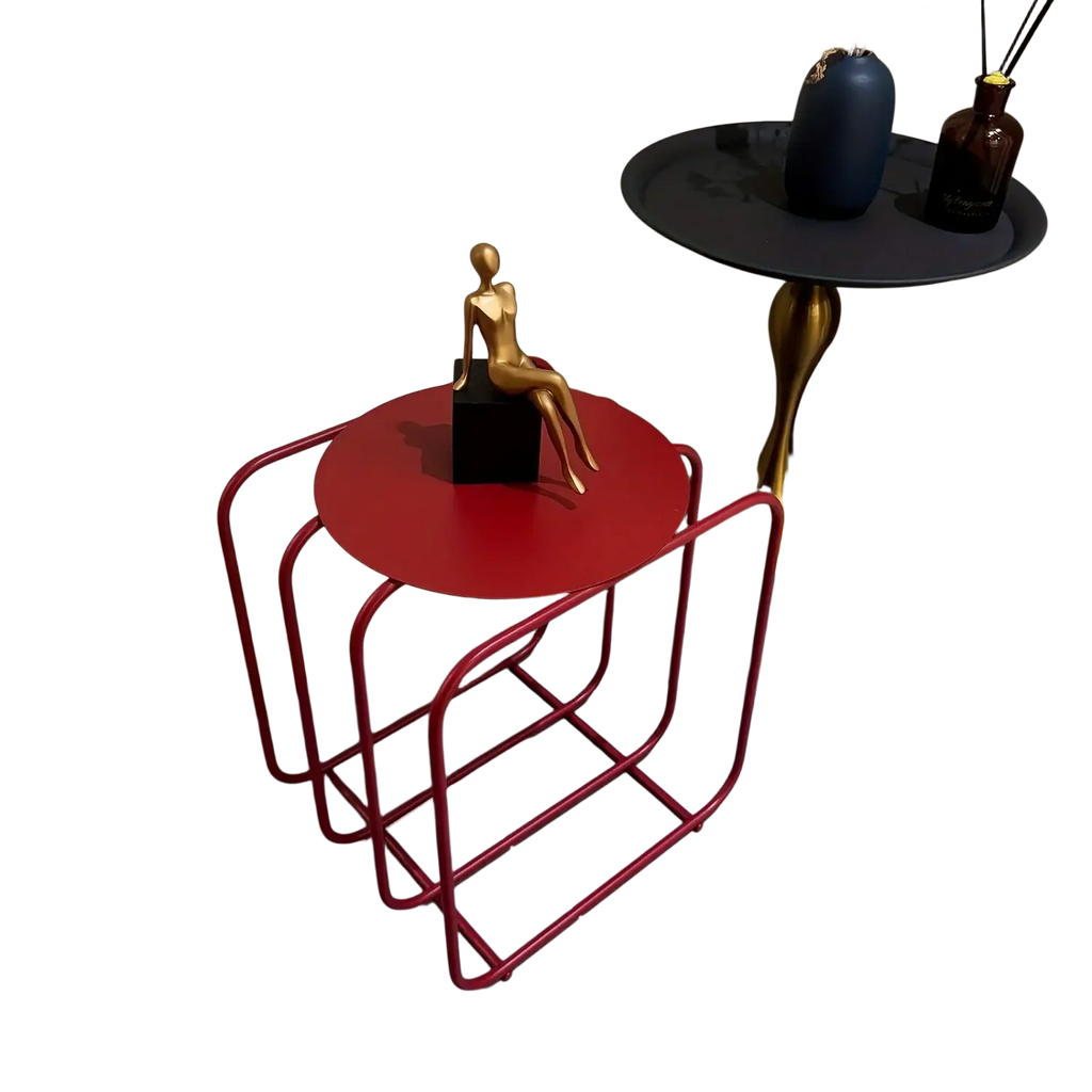Red circular metal side table with sleek minimalist frame and integrated magazine rack for storage and organization