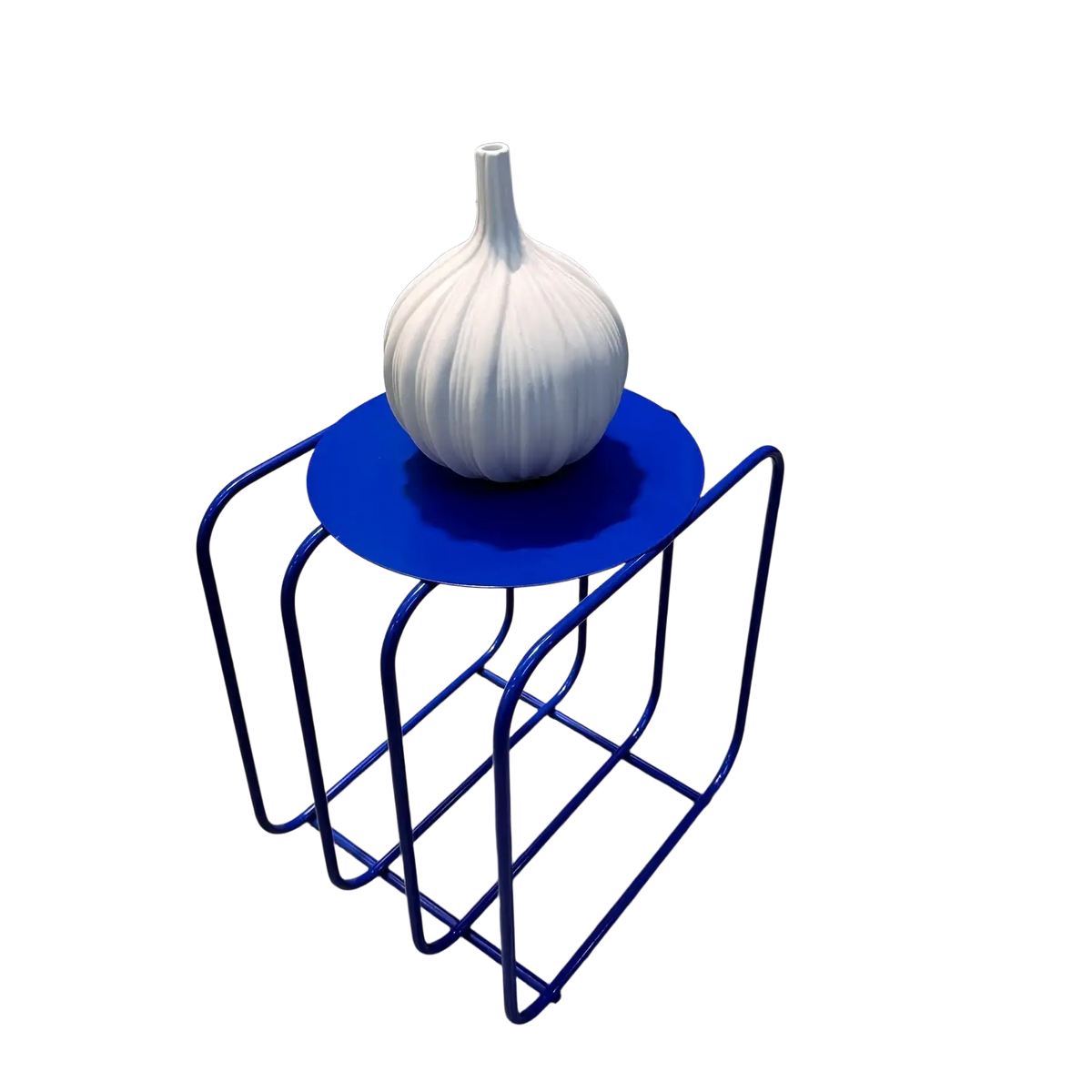 White ceramic garlic-shaped vase displayed on metal side table magazine rack with minimalist storage design