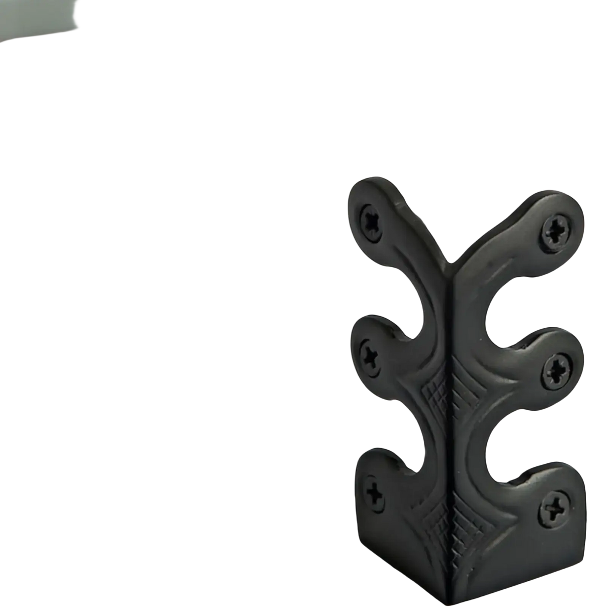 Black metal corner protector with ornate leaf design and four pre-drilled screw holes for skirting board edges