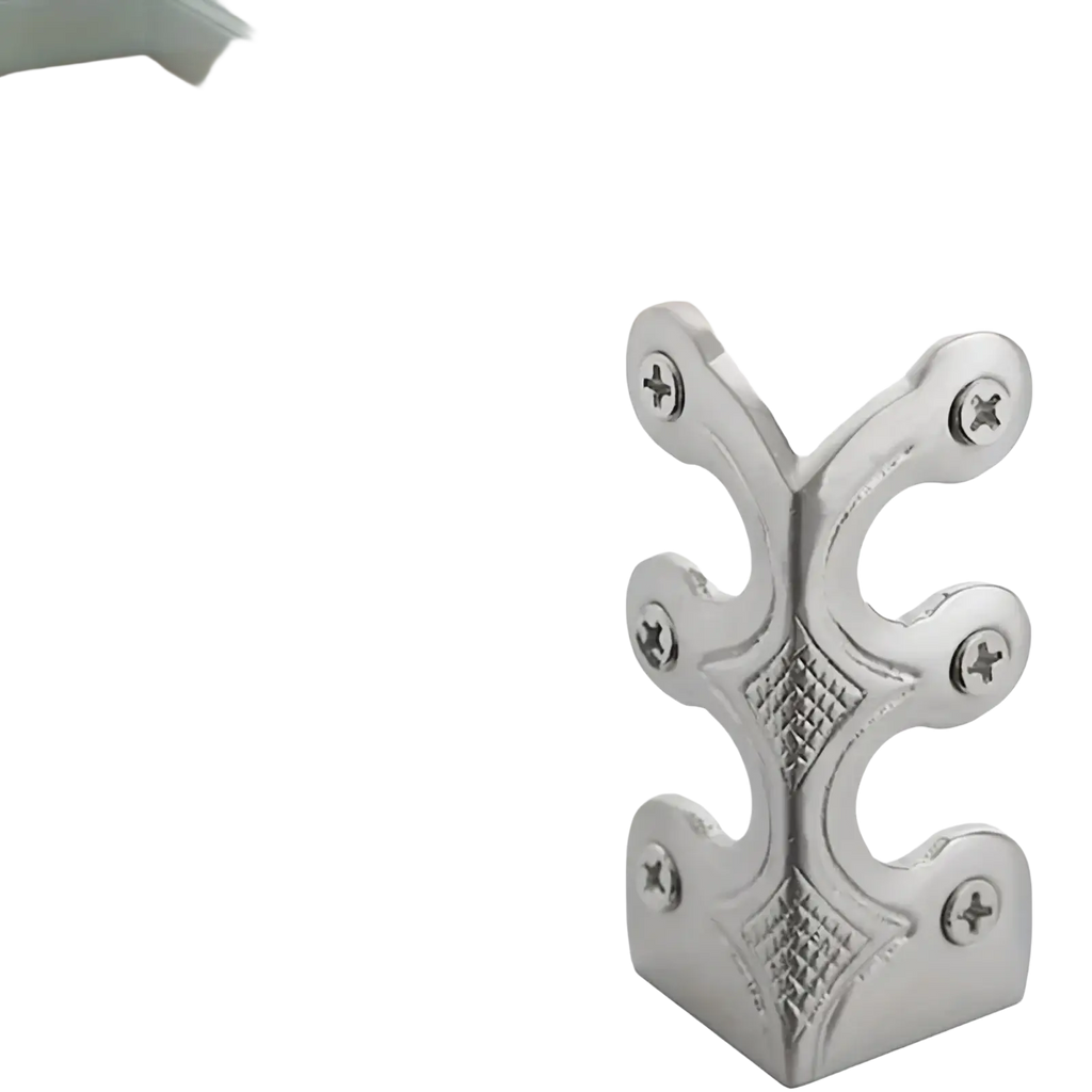 Silver metal skirting board corner protector with ornate leaf patterns and diamond-stitched detailing