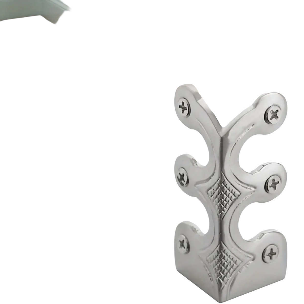 Silver metal skirting board corner protector with ornate leaf patterns and diamond-stitched detailing