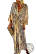 A shimmering gold and silver metallic bat sleeve pleated sequin maxi dress with a draped tie-front design