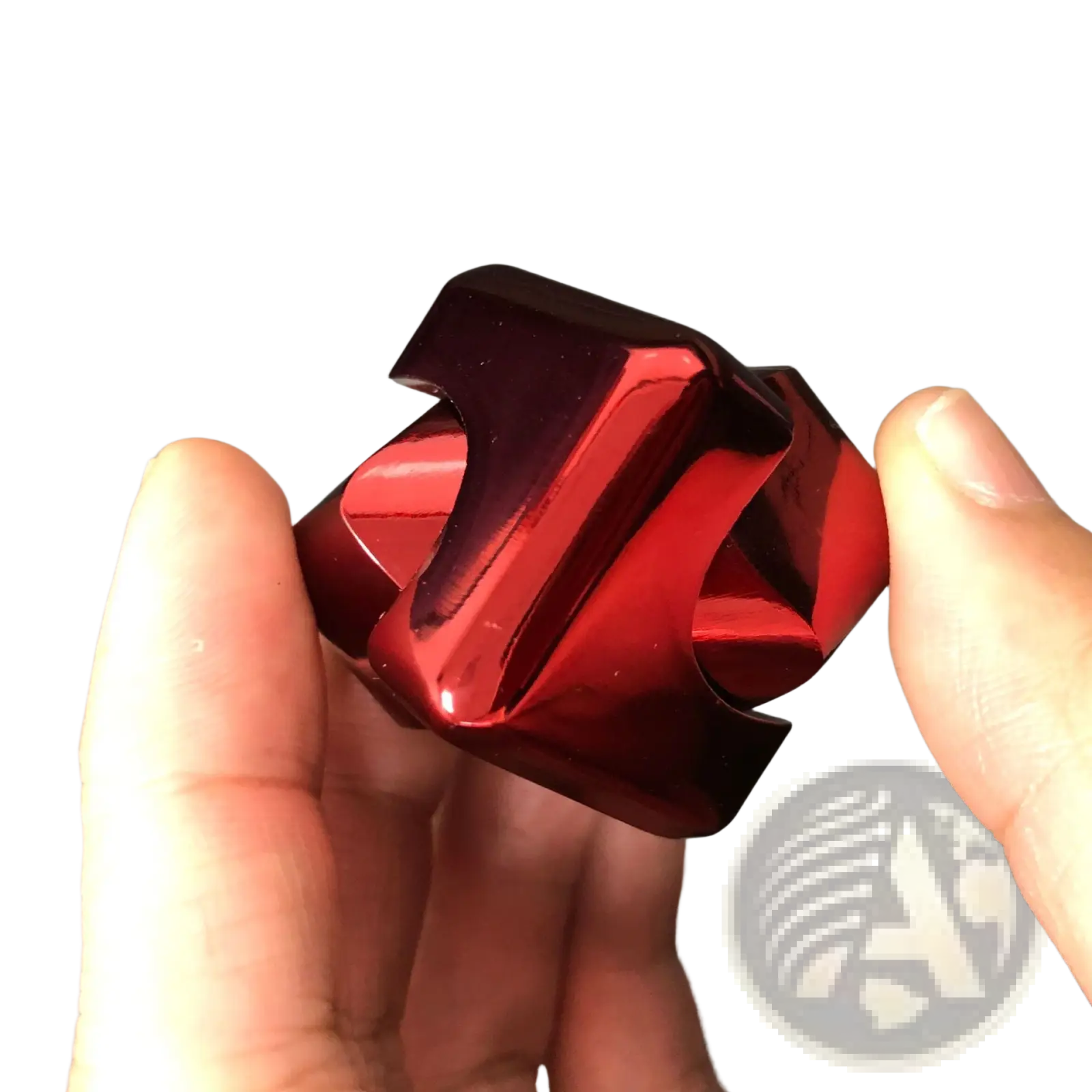 A glossy red metallic fidget cube with angular interlocking segments for stress relief toy use