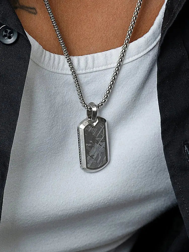Silver-toned muonionalusta meteorite dog tag necklace with textured dark gray meteorite inlay and stainless steel frame
