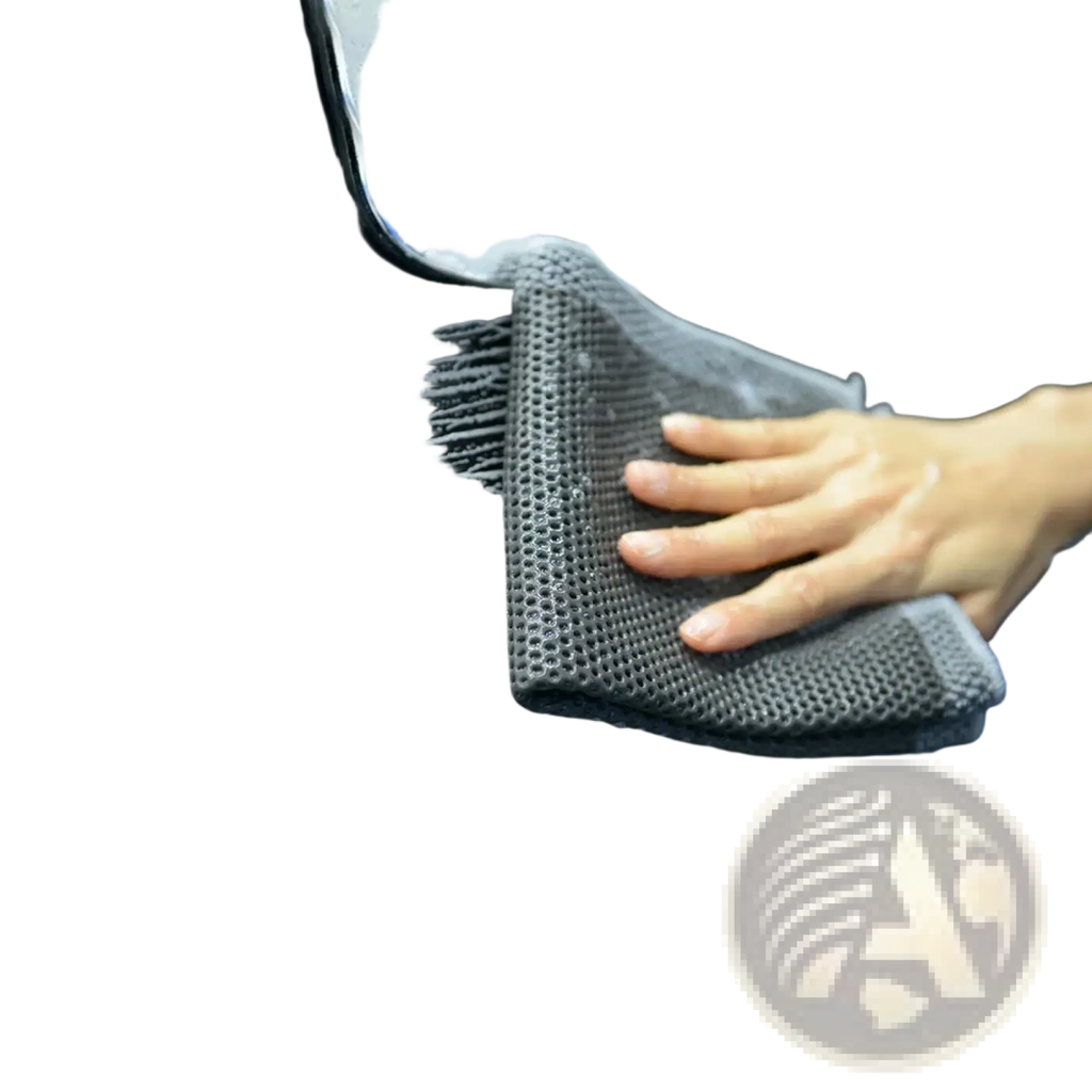 Gray textured microfiber car clay towel detailing cloth used as a mitt to scrub a black vehicle surface gently