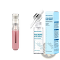 Pink handheld microneedle hydration roller with transparent top and silver hyaluronic acid serum bottle next to blue packaging
