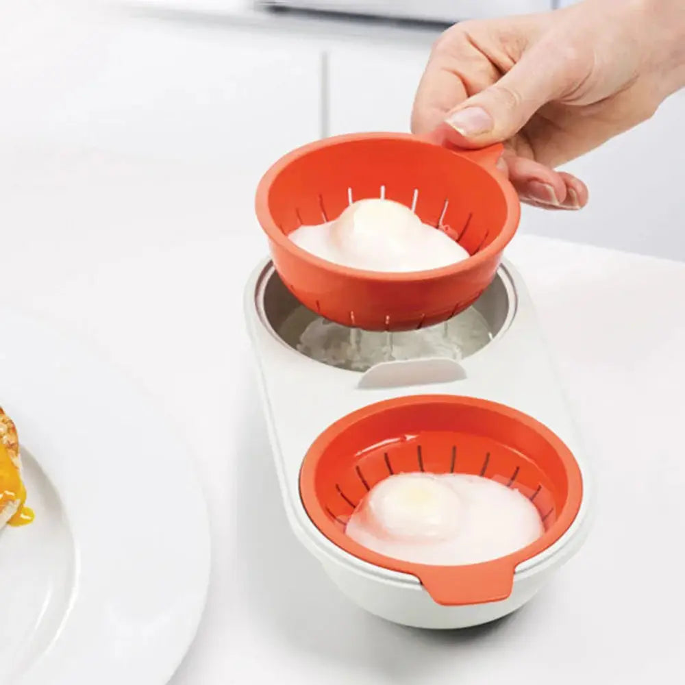Orange silicone microwave double cup egg poacher and boiler with white base and two compartments for quick cooking