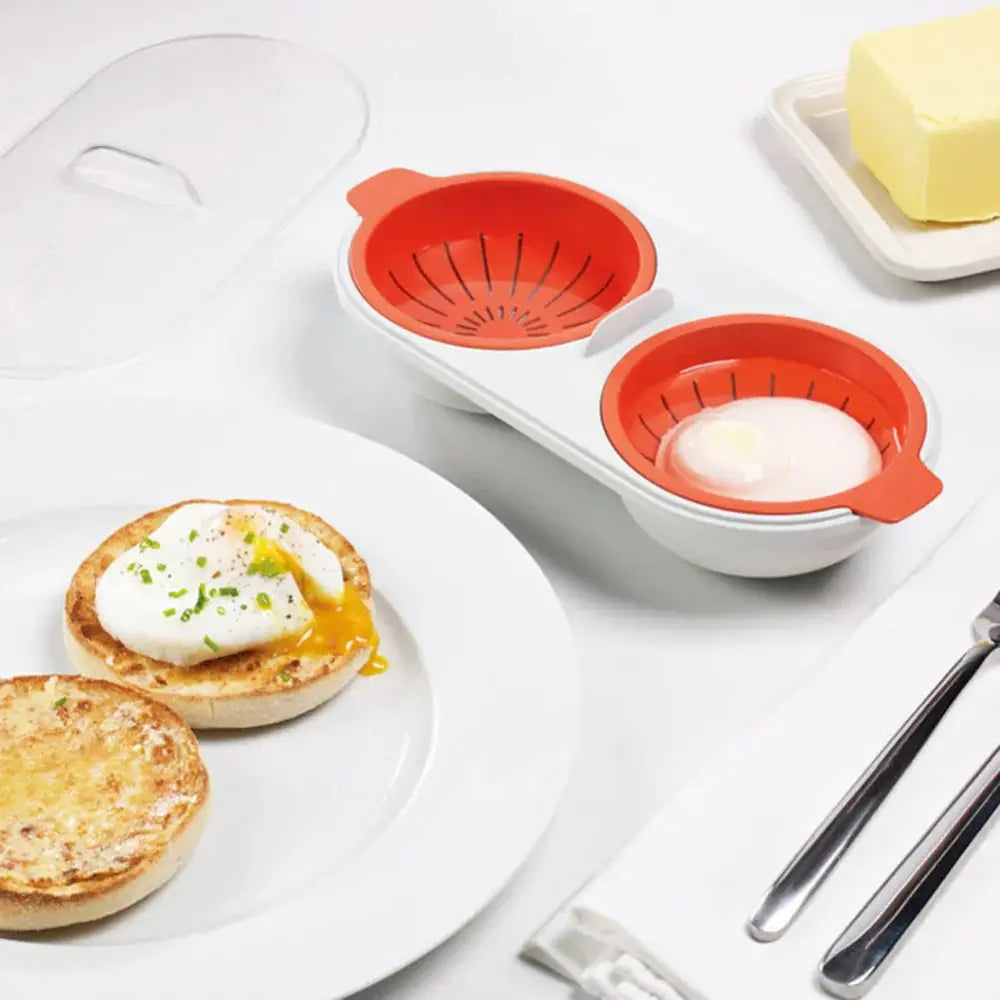 Orange silicone microwave double cup egg poacher and boiler with two compartments and a white base for easy cooking