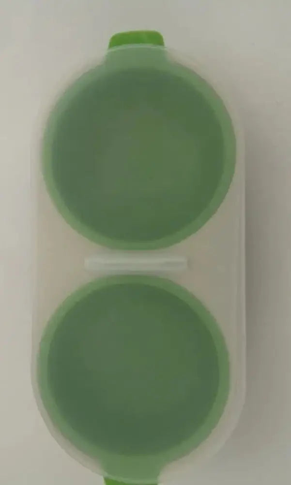 Green silicone microwave double cup egg poacher and boiler with two round compartments and matching lid