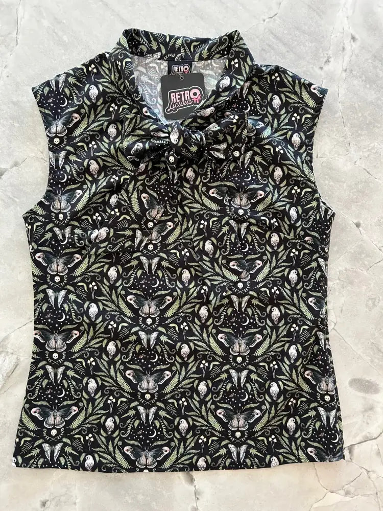 Black sleeveless blouse with a detailed pattern of white and light green butterflies skulls and foliage vintage style