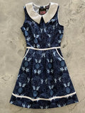 Navy blue sleeveless cotton a-line dress with white peter pan collar and whimsical fairy leaf pattern with pockets