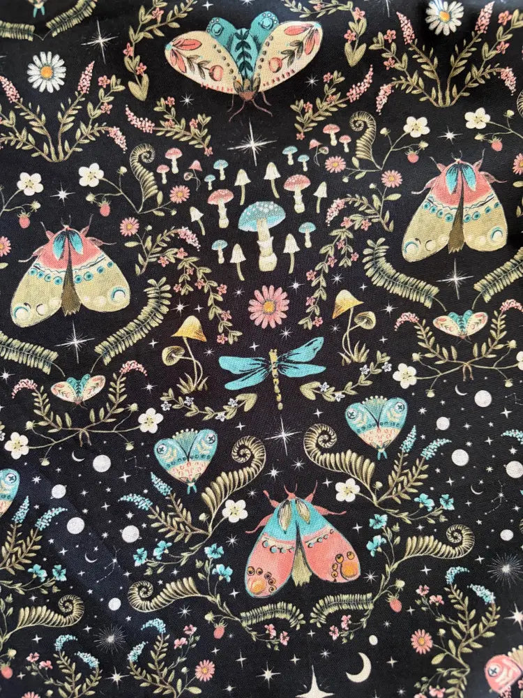 Midnight Doris black pleated skirt with whimsical pastel moths mushrooms flowers and stars pattern