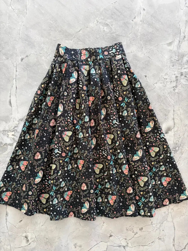 Midnight doris black pleated skirt with pastel butterfly moon and star pattern on lightweight fabric