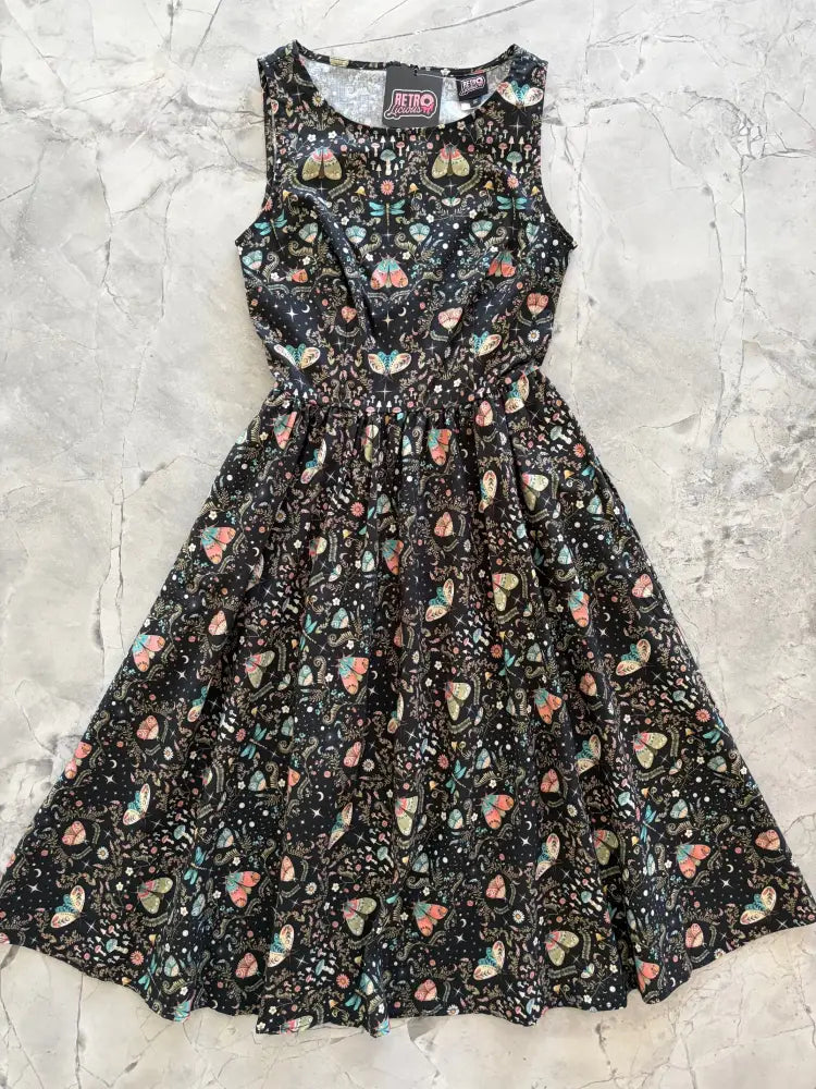 A black sleeveless cotton a-line midi dress with colorful butterfly dragonfly and celestial print for evening wear