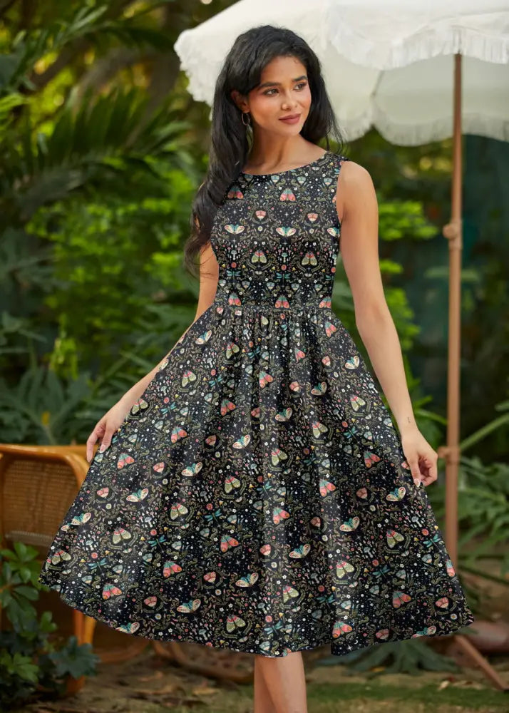 Black sleeveless cotton a-line midi dress with colorful butterfly and heart print called midnight butterfly print