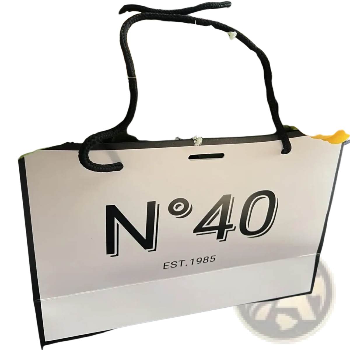 White paper shopping bag with black handles and bold n40 branding for milestone birthday gift with card and ribbon