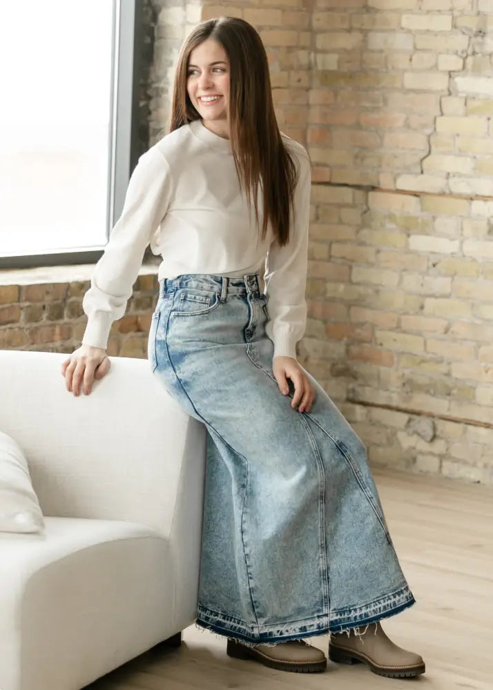 Mina frayed hem light wash denim maxi skirt featuring a flowing high waist design in light-wash denim fabric
