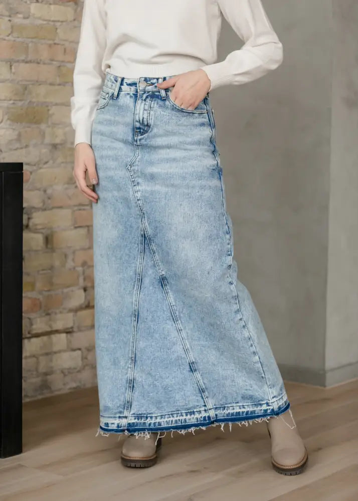 Mina frayed hem light wash denim maxi skirt with blue stitching showcasing a casual and stylish design