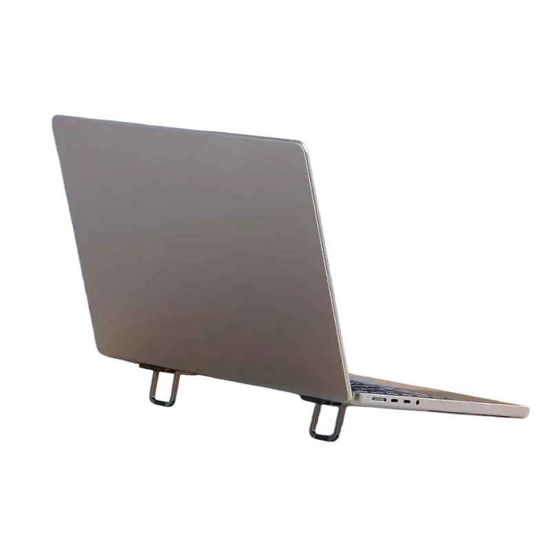 Silver mini aluminum laptop stand supporting a sleek metallic laptop on a wooden table for portable notebook support