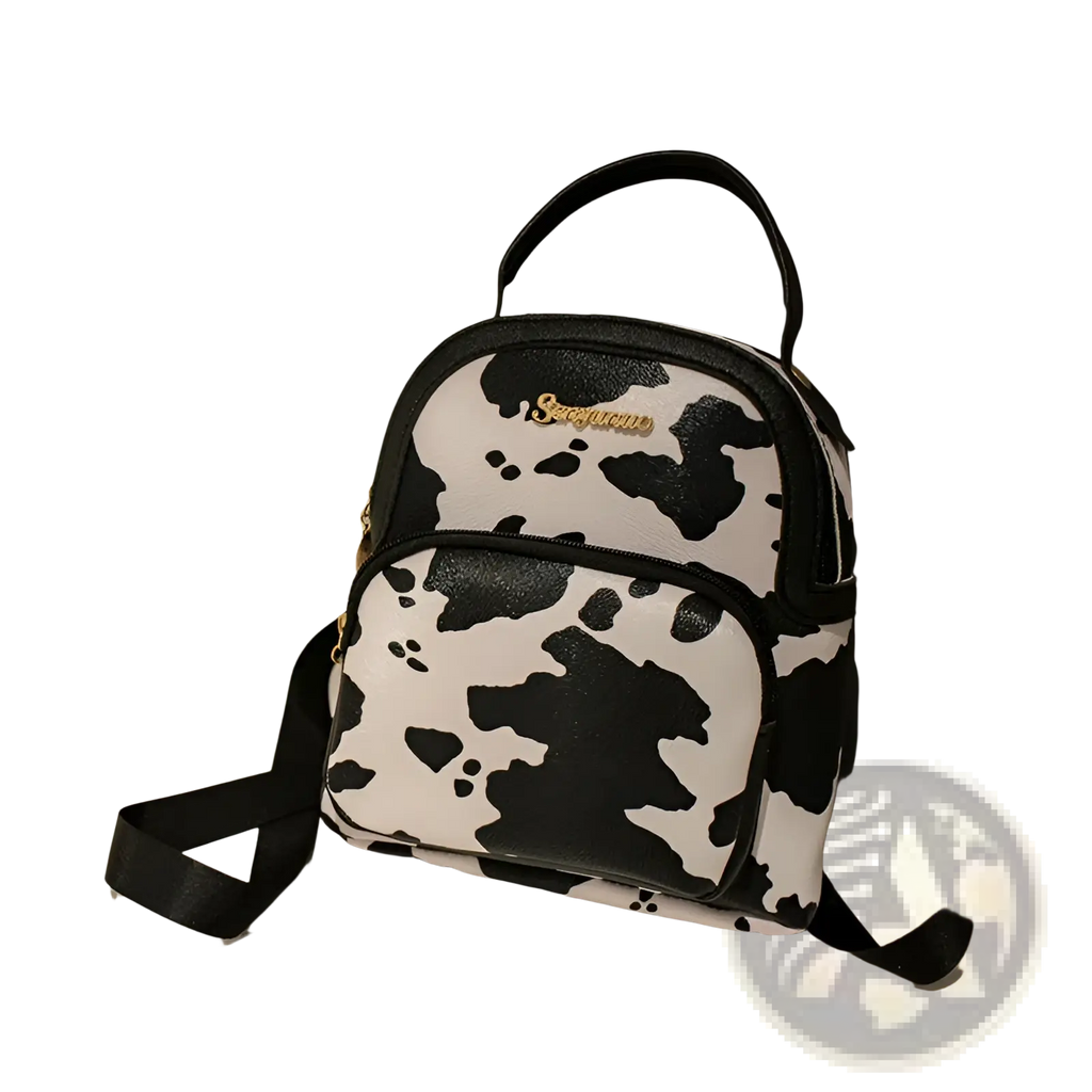 Mini backpack in black and white cow print with gold-tone logo detailing in Korean style design
