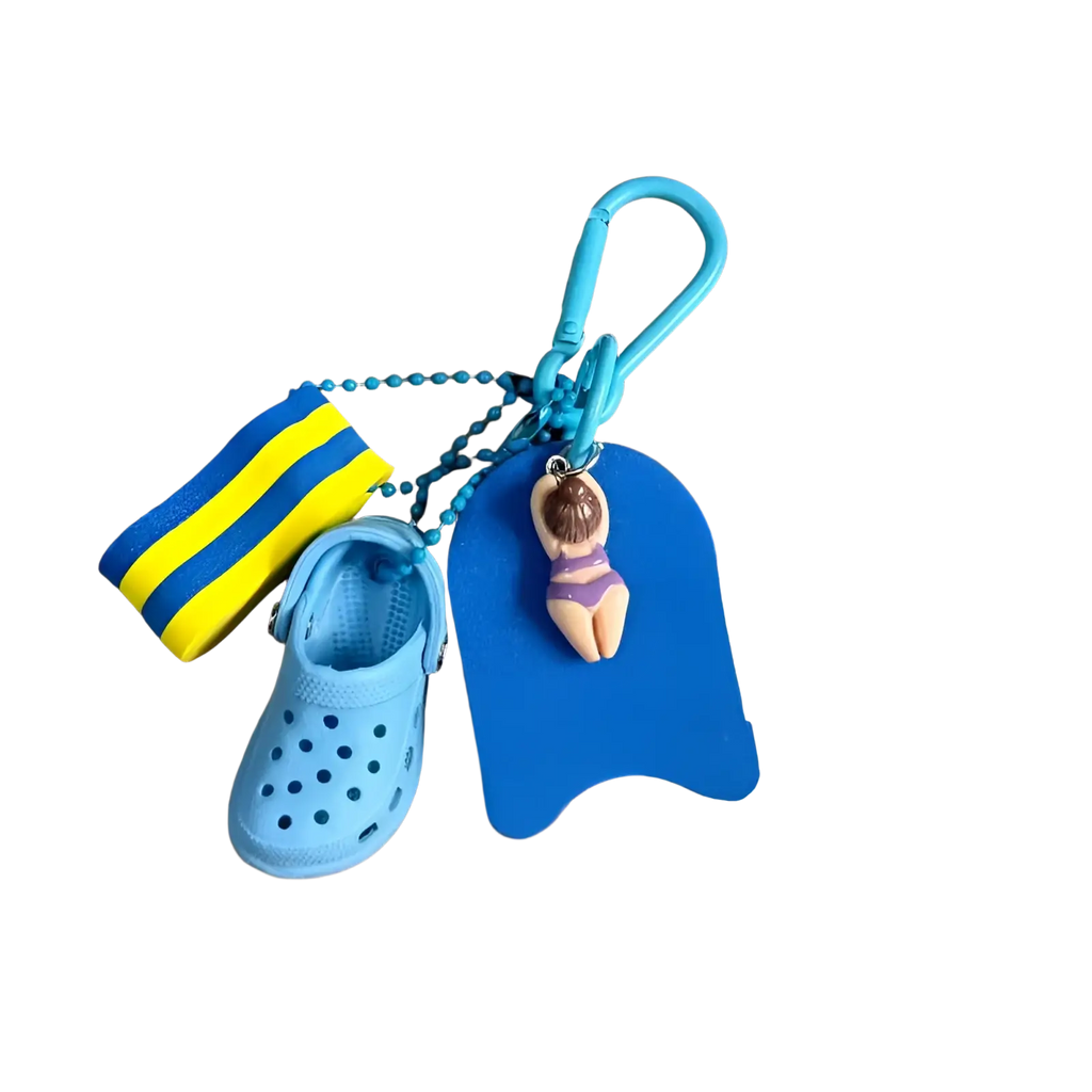 Mini clog keychain beach bag charm featuring a blue miniature croc shoe striped swim sock and buoy-shaped keychain with figurine