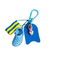 Mini clog keychain beach bag charm featuring a blue miniature croc shoe striped swim sock and buoy-shaped keychain with figurine