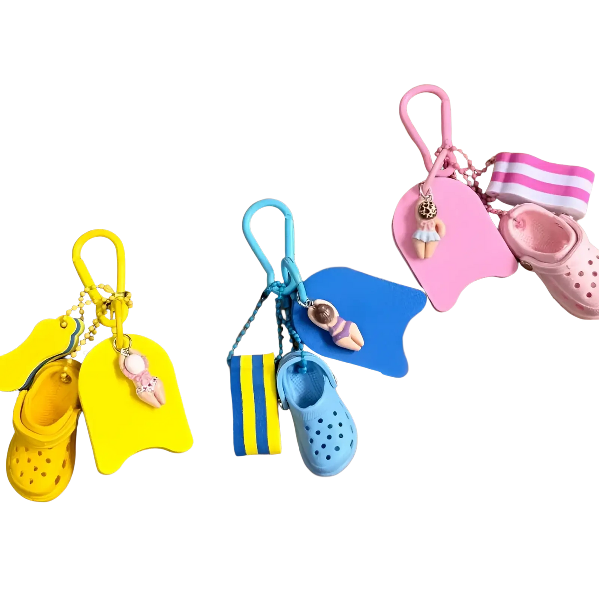 Brightly colored miniature crocs-themed mini clog keychain beach bag charm with tiny swim floats and flip-flops in yellow blue and pink