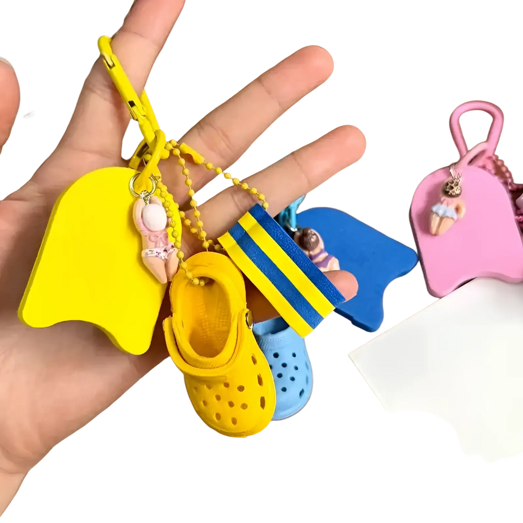 Mini clog keychain in yellow with a miniature croc shoe, matching floatie charm, and blue yellow striped flag accessory