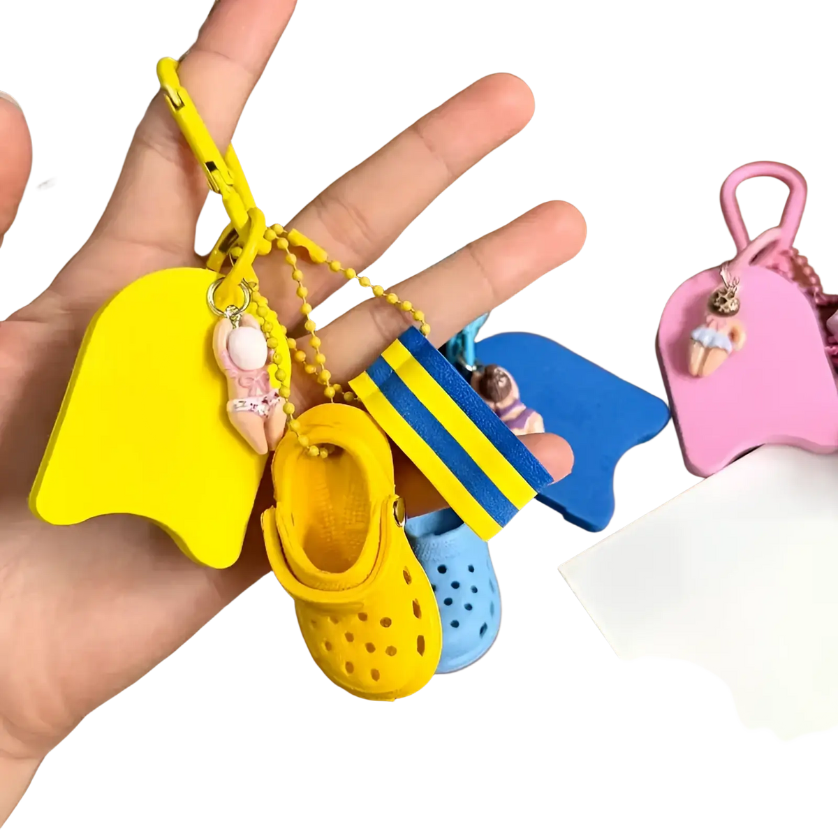 Mini clog keychain in yellow with a miniature croc shoe, matching floatie charm, and blue yellow striped flag accessory