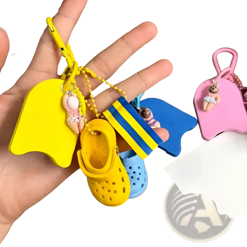 Mini clog keychain in yellow with a miniature croc shoe, matching floatie charm, and blue yellow striped flag accessory