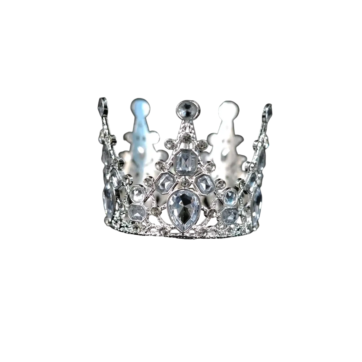 A sparkling silver mini crown cake topper and hair tiara with clear and light blue crystals and a central teardrop gemstone